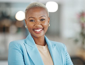 Professional woman smiling after seeing a Delta Dental dentist in Plano