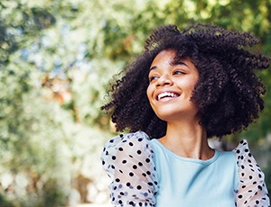 Plano teen smiling with clear aligners in