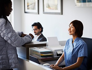 an insurance coordinator speaking with a patient