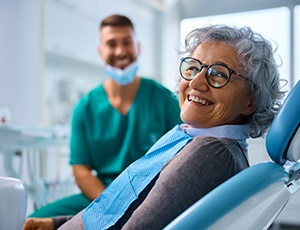 a smiling woman sitting in a dental chair