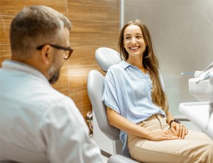 Female patient smiling at dentist at dental appointment