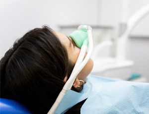 Woman breathing in nitrous oxide