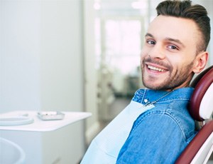 Man smiling while sitting in treatment chair